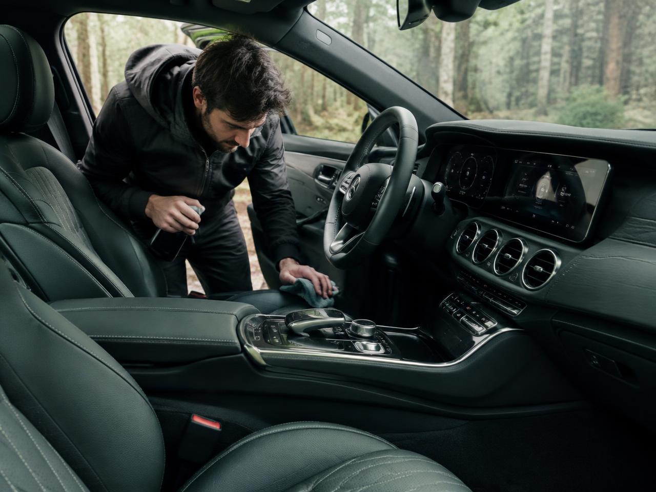 Detailer wiping down a leather car interior